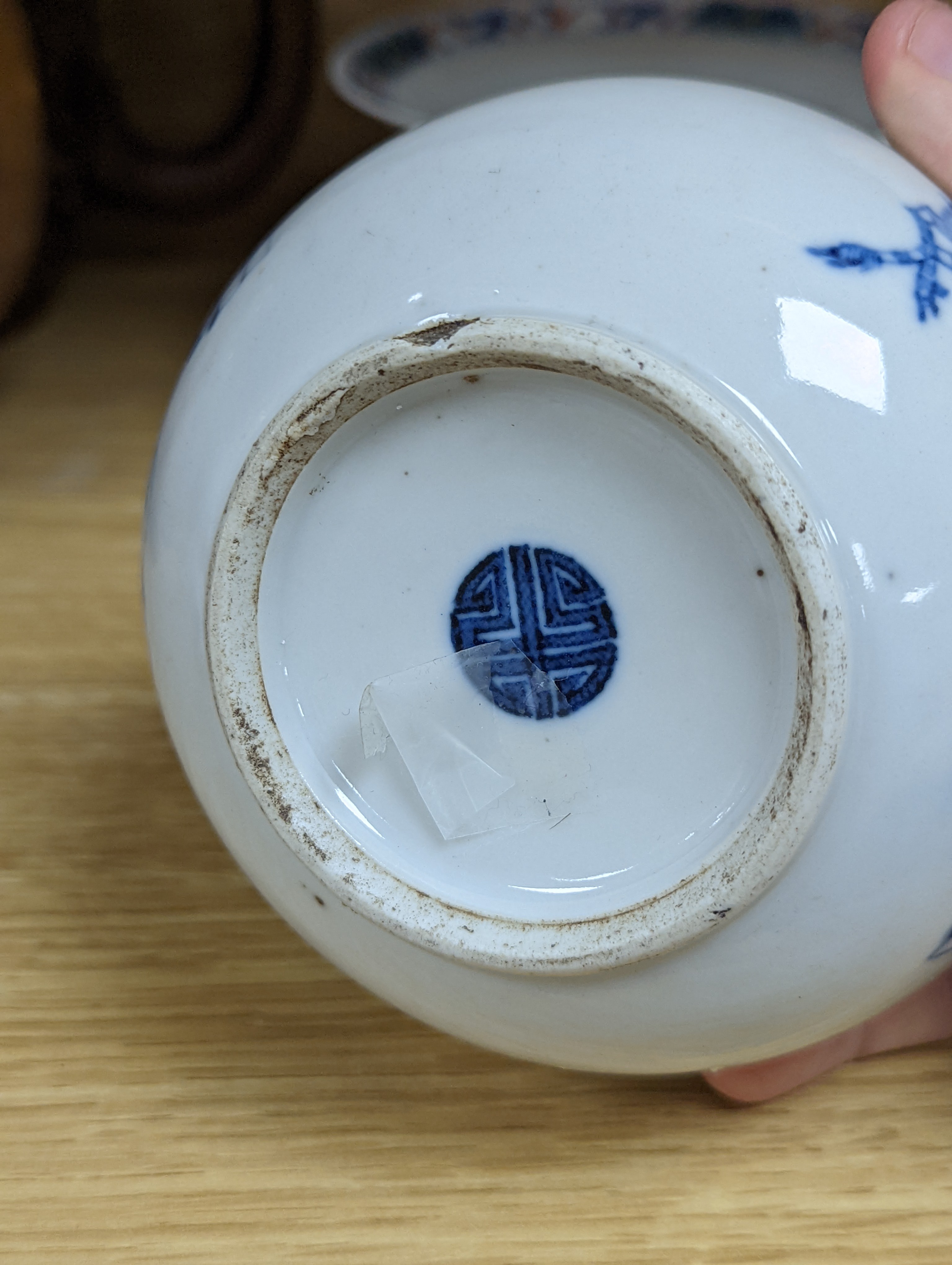 A Chinese blue and white water pipe vessel, a doucai stem dish and a Japanese Imari bowl, 19th century, (3)